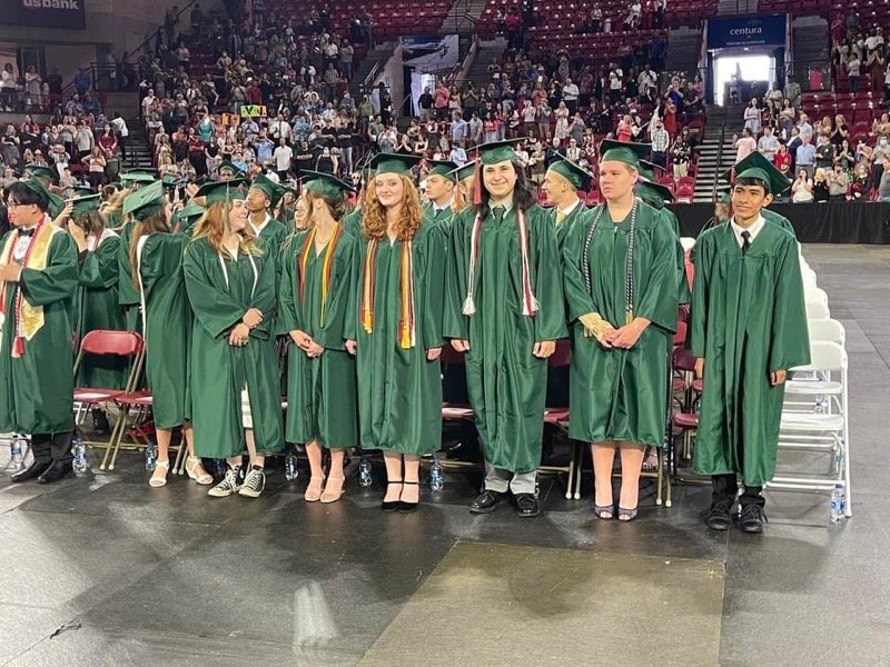 Seniors stand at Smoky Hill High School's graduation ceremony in late May.